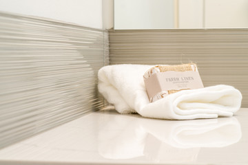 Fototapeta na wymiar Detail of marble vanity in luxury bathroom with hand towel and soap