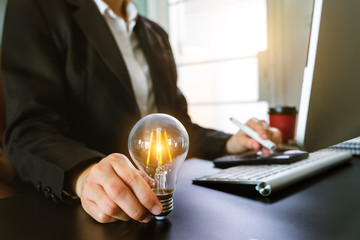 business hand showing creative business strategy with light bulb as concept