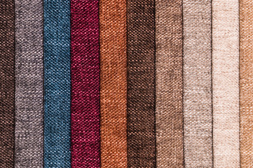 A set of samples of fabric furniture decoration lines of textile textures. Multicolored stripes upholstery. Mode and tone for a luxurious interior style. Abstract background
