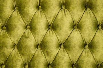 Velor lime surface of sofa close-up. Training equipment-velor mats tightened with buttons. Yellow chesterfield style quilted upholstery background