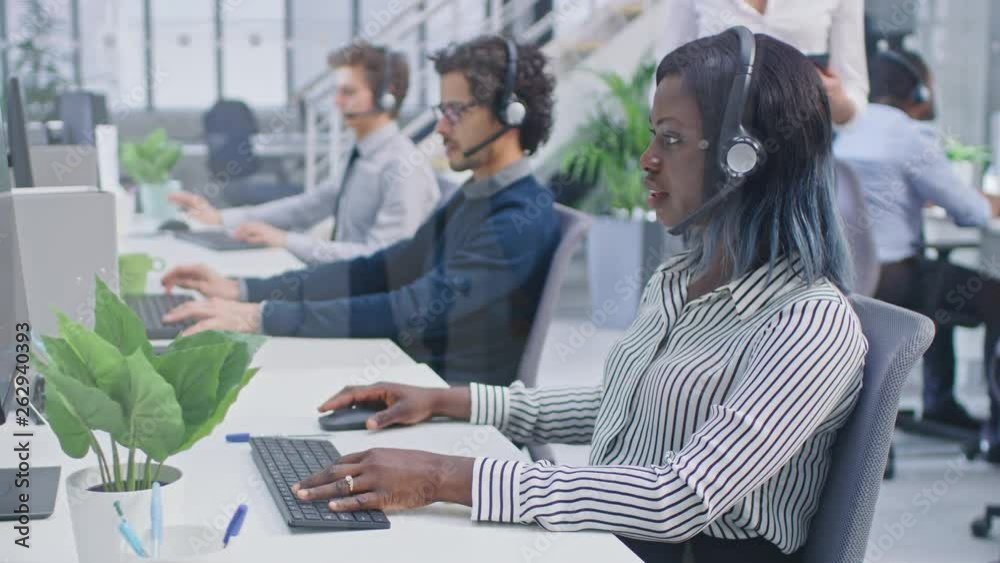 Aufkleber Team of Handsome and Beautiful Diverse Multicultural Customer Service Operators Working at a Busy Modern Call Center with Specialists Wearing Headsets and Actively Taking Calls. 