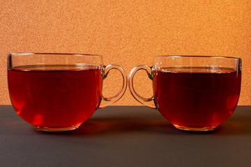 two glass cups of tea on a light background. close-up