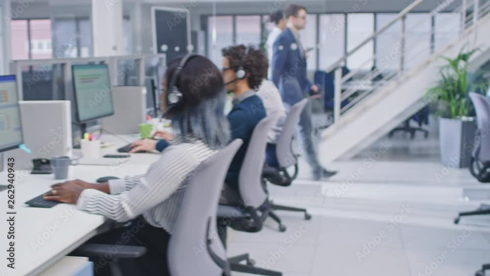 Aufkleber Team of Handsome and Beautiful Diverse Multicultural Customer Service Operators Working at a Busy Modern Call Center with Specialists Wearing Headsets and Actively Taking Calls. 