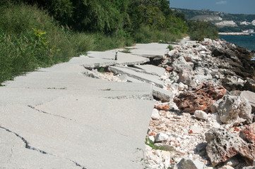Destroyed by sea water erosion process seaside promenade concrete cover surface