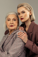 Nice serious mother and daughter posing for a photo