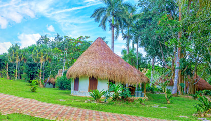 Fototapeta na wymiar Gazebo in the park with thatched roof.