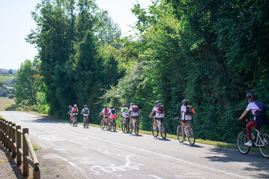 Teenagers group bike ride in the countryside - south France. Summer camp. Sports and outdoor activities conception.