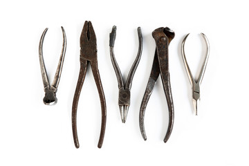 Old tools lie on a white isolated background. Chisels, wire cutters,  pliers, tongs and other tools.