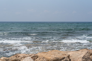 Fototapeta na wymiar Waves on the beach. Clean background. Green storm sea.