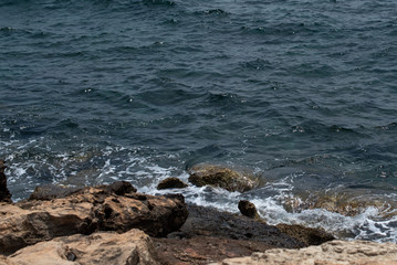 Sea and rocks. Translucent sea with a stone bottom.