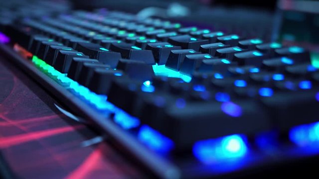 Keyboard with neon light. Esports. Championship in computer games. Streaming to the internet. Gaming computer, laptop. Ultra customization