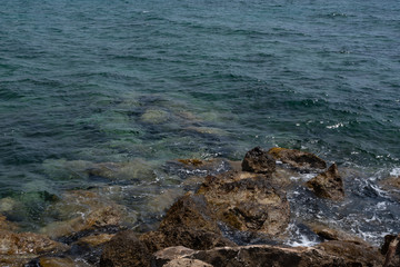 Sea and rocks. Translucent sea with a stone bottom.