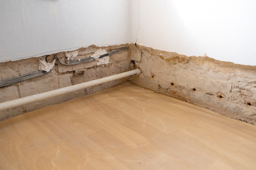 repairing an old destroyed wall with heat and electricity lines and repairing masonry insulation