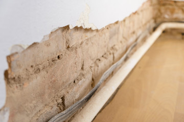 repairing old destroyed wall with heat and electricity lines