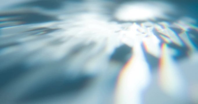 Overflows of Diamond Edges. Loop. The light passes through the facets of a slowly rotating diamond and creates repetitive sparkling highlights and rainbow colors