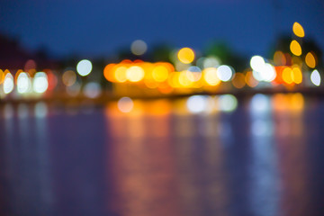 Beautiful blurred city lights with bokeh effect reflected on water