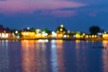 Beautiful blurred city lights with bokeh effect reflected on water