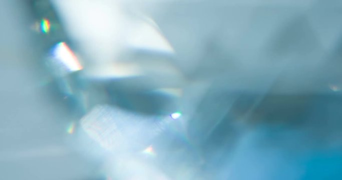 Sparkling Diamond Glare. Loop. The light passes through the facets of a slowly rotating diamond and creates repetitive sparkling highlights and rainbow colors