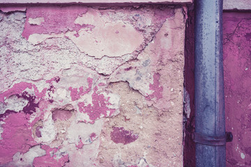 gutter in front of an old wall