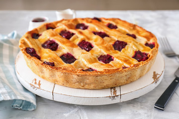 Tasty cherry pie on table