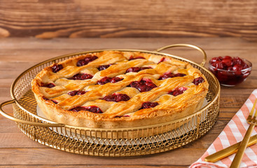 Tasty cherry pie on wooden table