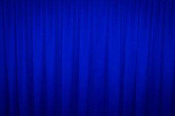 Blue closed curtain with a light spot