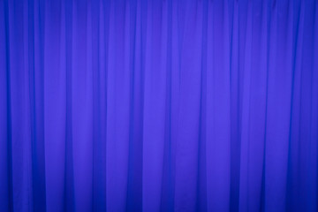 Blue closed curtain with a light spot