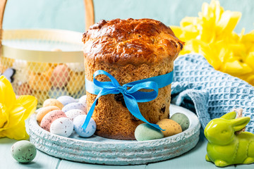 Easter orthodox sweet bread, kulich and colorful quail eggs. Holidays breakfast concept