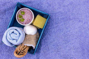 Obraz na płótnie Canvas Natural herbal spa cosmetics with lavender extract - soap, salt, towel, massage brush, washcloth