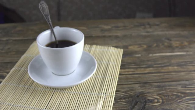 Coffee cup on rotating background