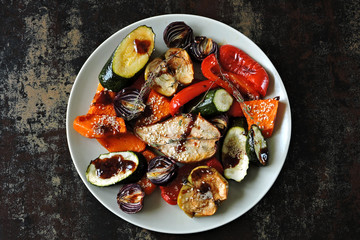 Baked vegetables and fruits with sesame on the plate. Vegan food. Healthy diet.