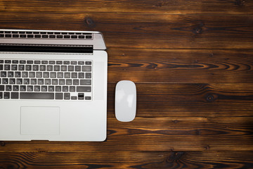 laptop on wooden background top view