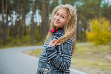 Little fashionable girl in warm clothes walk outdoor, Autumn - Winter season, holidays and children concept. Sweet girl at European street 