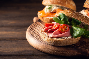 Sandwiche with beef, fresh tomatoes and lamb's lettuce, multigrain bun. Healthy lunch concept with copy space