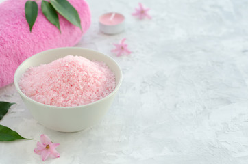 Sea salt, towel and hyacinth flowers on concrete background.