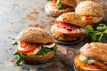 Italian Caprese sandwiches with fresh tomatoes, mozzarella cheese and lamb's lettuce, multigrain bun. Healthy food concept with copy space