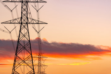 High voltage electric pole and transmission lines in the evening. Electricity pylons at sunset....