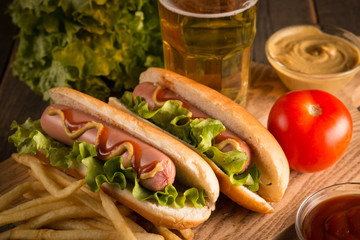 Photo of barbecue grilled hot dog with yellow mustard and ketchup on wooden background. Hot dog...