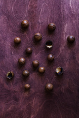 Macadamia nut on wooden brown table. Top view.