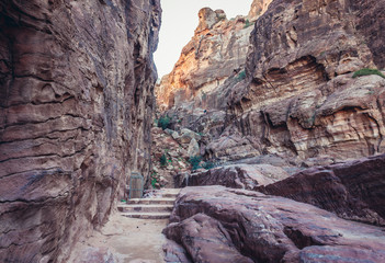 Stairs to a mountains above so called Facades Street in ancient Petra city in Jordan