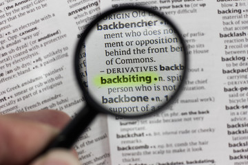 The word or phrase backbiting in a dictionary.