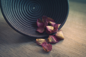 Dried rose petals: for tea, alternative medicine, pot-pourri in wooden bowl.