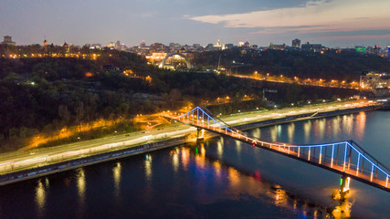 Fototapeta na wymiar aerial night city view, luminous buildings and bridge. Drone shot