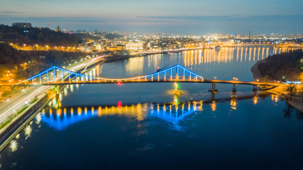 Fototapeta na wymiar aerial night city view, luminous buildings and bridge. Drone shot