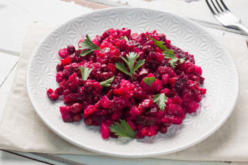 Fresh homemade Beetroot salad Vinaigrette in a white bowl. Traditional Russian food.
