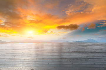 Empty wooden planks platform and mountain with clouds landscape