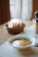Nice and hot soup at the white ceramic plate at the restaurant.