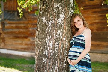 Outdoor portrait of beautiful pregnant woman