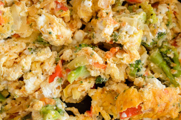 Omelette with vegetables filling the whole frame.