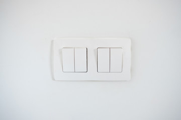 White light switches on the white wall